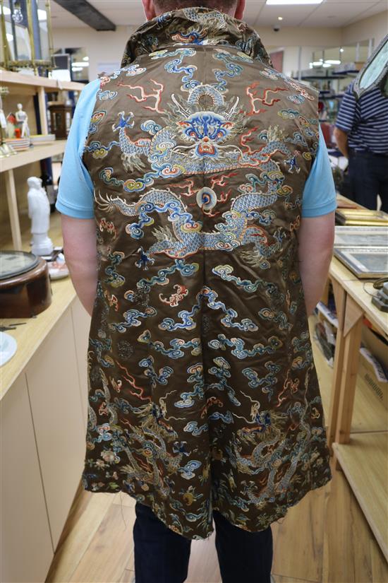 A Chinese black ground polychrome silk embroidered robe (a.f.)